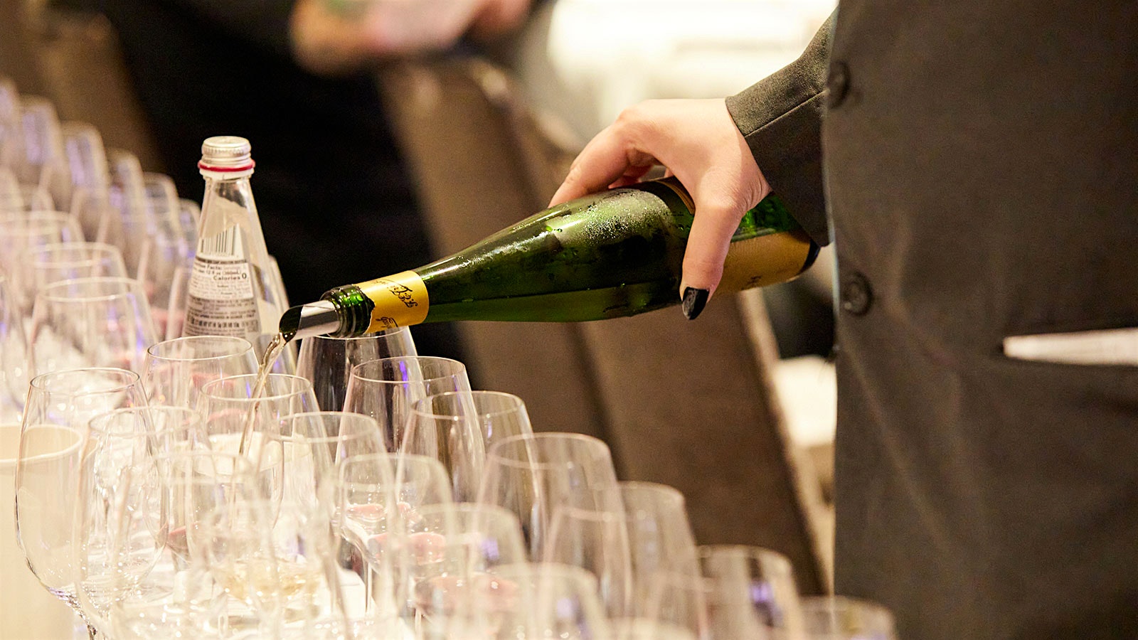 A server pours glasses of Trimbach riesling.